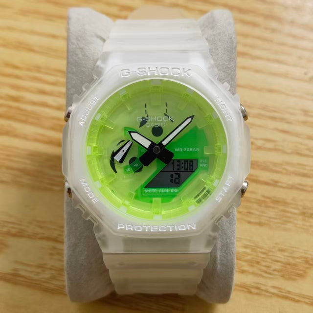 A Casio G-Shock watch with a translucent white resin case and a bright neon green dial, displayed on a gray velvet watch stand over a light wood surface.